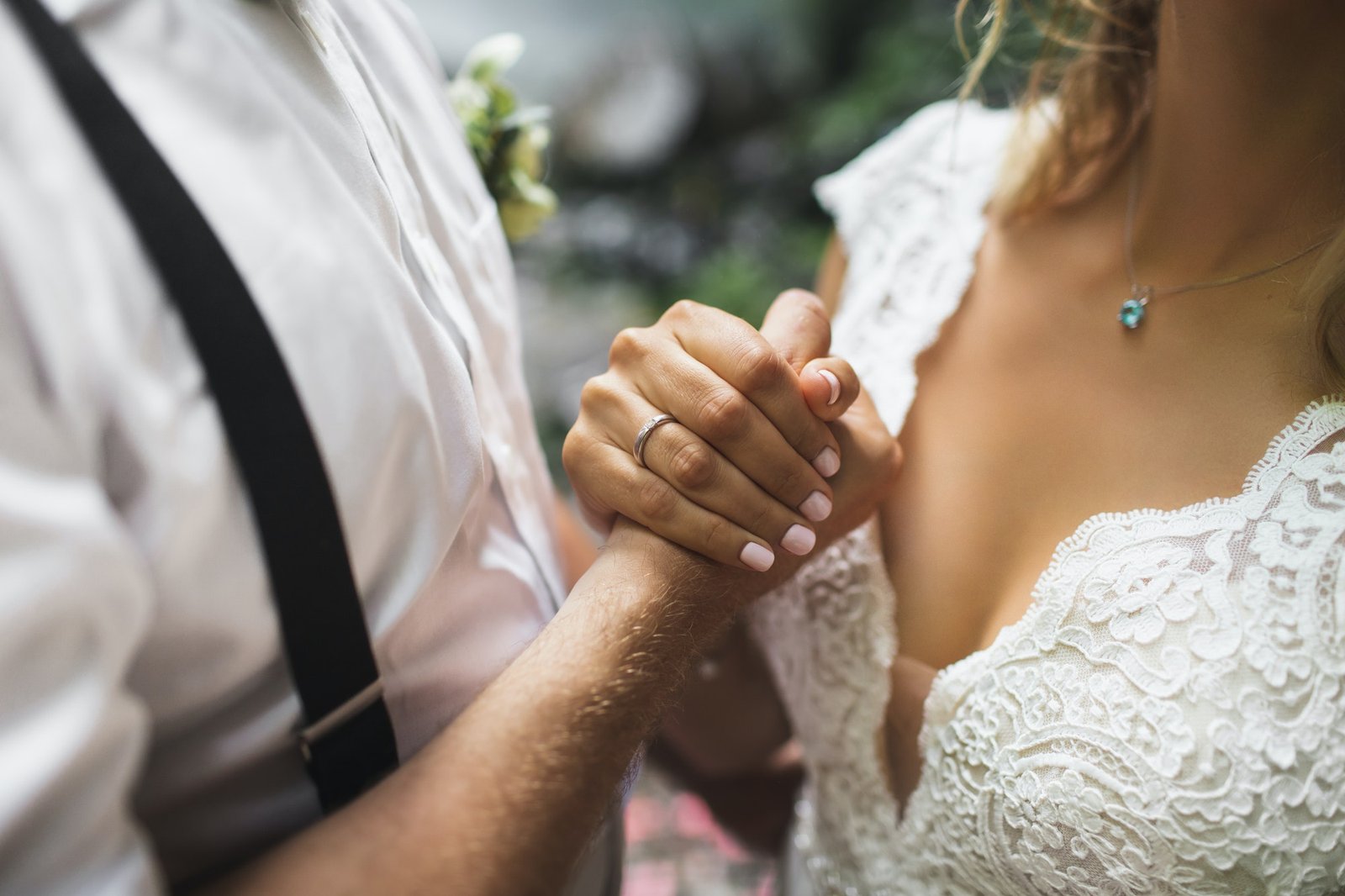 groom-and-bride-holding-hands-together-symbol-of-love-and-commitment.jpg